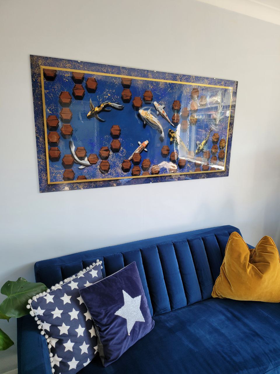 Airbrushed Painting of Koi Fish on Blue Background Mounted on a wall